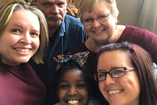 Lauren Emanuelson and a group of people pose for a selfie