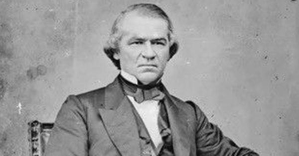 Black and white portrait of a stern-looking man in a 19th-century suit, seated against a plain backdrop.