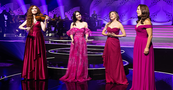 The Irish musical group Celtic Woman performing on stage during their 20th Anniversary Concert special. Featured performers in this special include soprano Mairéad Carlin, violinist Tara McNeill, Muirgen O'Mahony, and Emma Warren. 