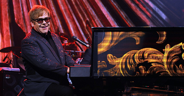 Elton John Performing at the piano.
