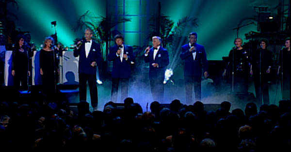 Singers performing on stage.