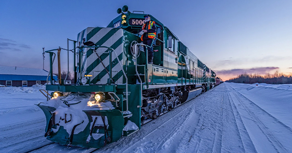 Diesel train engine on snow covered tracks.