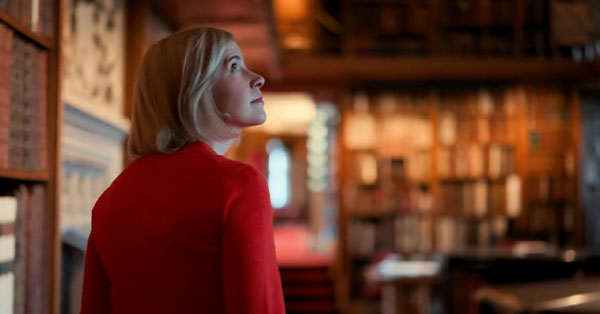 Lucy Worsley walks into a room.